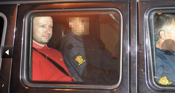 Behring Anders Breivik (in red), twice-confessed author of the attack which cost the lives of more than 90 people in Norway, leaving the court today in Oslo. Photo: Reuters