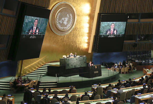 Large video monitors broadcast Cuba's Foreign Minister Bruno Rodríguez as he address a meeting of the U.N. General Assembly, Wednesday Oct. 26, 2016 at U.N. headquarters. The United States has abstained for the first time in 25 years on a U.N. resolution condemning America's economic embargo against Cuba, a measure it had always vehemently opposed. (AP Photo/Bebeto Matthews)