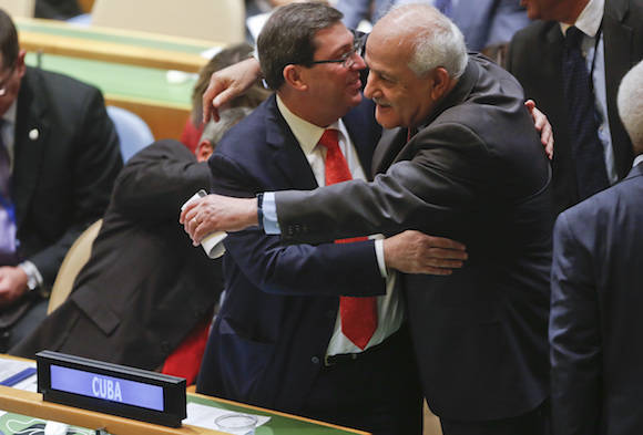Palestinian Authority Ambassador to the U.N. Riyad Mansour, right, hugs Cuba's Foreign Minister Bruno Rodríguez after a resolution vote in the U.N. General Assembly, Wednesday Oct. 26, 2016 at U.N. headquarters. The United States has abstained for the first time in 25 years on a U.N. resolution condemning America's economic embargo against Cuba, a measure it had always vehemently opposed. (AP Photo/Bebeto Matthews)